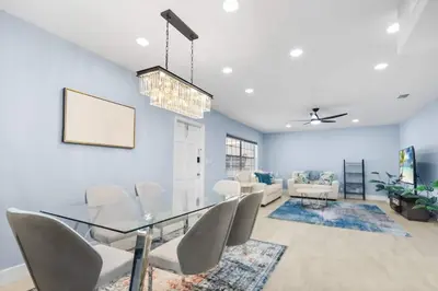 a dining room with a glass table and chairs at Las Olas & Beachside getaway with pool in Fort Lauderdale