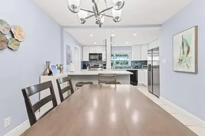 a dining room and kitchen with a table and chairs at Beach Pool & Las Olas Getaway Fort Lauderdale in Fort Lauderdale