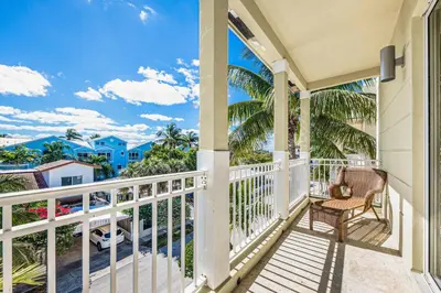 a balcony with a chair and a view of the ocean at Walk to Hollywood Beach Luxury Family Getaway! in Hollywood