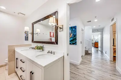 a white bathroom with a sink and a mirror at Walk to Hollywood Beach Luxury Family Getaway! in Hollywood