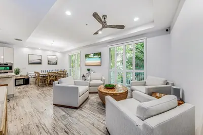 a living room with white furniture and a kitchen at Walk to Hollywood Beach Luxury Family Getaway! in Hollywood