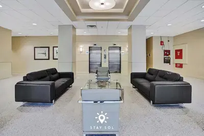 a waiting room with two couches and a table at Modern Hollywood Beach Escape - City Views in Hollywood