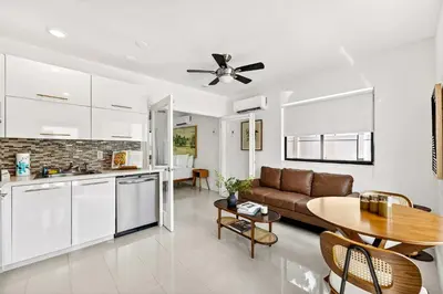 a kitchen and living room with a couch and a table at Sleek Kitchenette & Queen Bed in Fort Lauderdale