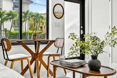 a living room with a table and chairs and a window at Sleek Kitchenette & Queen Bed in Fort Lauderdale