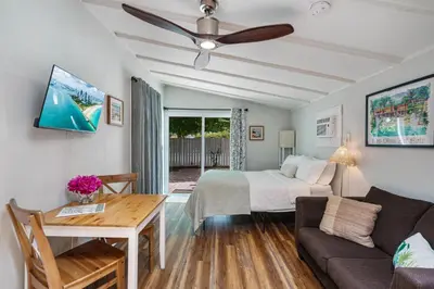 a living room with a bed and a couch at Jungle Fortress in Fort Lauderdale