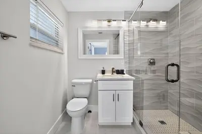 a white bathroom with a toilet and a shower at 2BR Home Near Wilton Manors & Downtown in Fort Lauderdale