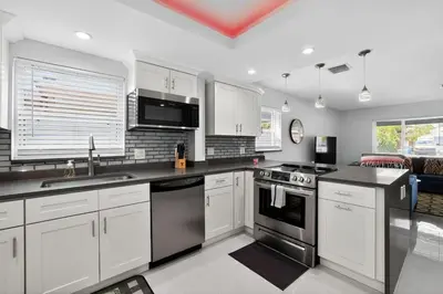 a kitchen with white cabinets and stainless steel appliances at 2BR Home Near Wilton Manors & Downtown in Fort Lauderdale