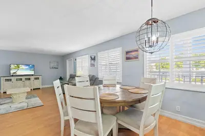 a dining room with a table and chairs at Beachside Las Olas Getaway Oasis with Pool in Fort Lauderdale