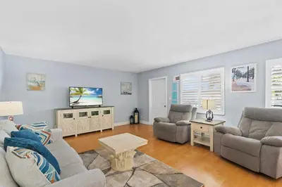 a living room with two couches and a tv at Beachside Las Olas Getaway Oasis with Pool in Fort Lauderdale