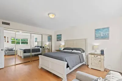 a bedroom with a bed and a living room at Beachside Las Olas Getaway Oasis with Pool in Fort Lauderdale