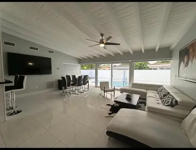 a living room with a couch and a ceiling fan at Miami Lifestyle, Modern, Private heated Pool, BBQ in North Miami Beach