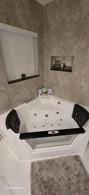 a white bath tub with a sink in a bathroom at Miami Lifestyle, Modern, Private heated Pool, BBQ in North Miami Beach