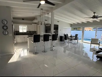 a kitchen and dining room with a table and chairs at Miami Lifestyle, Modern, Private heated Pool, BBQ in North Miami Beach