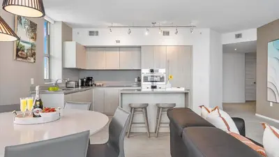 a kitchen and living room with a table and a couch at Hyde House in Hollywood