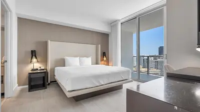 a bedroom with a white bed and a large window at Hyde House in Hollywood