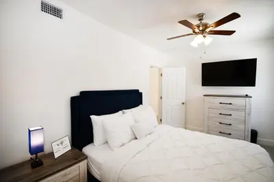 a bedroom with a bed and a ceiling fan at Coastal Collection in Fort Lauderdale