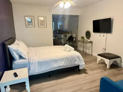a bedroom with a bed and a television in it at Sunny Miami Beach Getaway , Steps from the Ocean! in Miami Beach