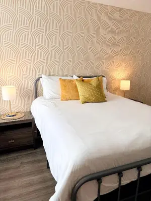 a bed with two pillows on it in a bedroom at Sunny Miami Beach Getaway , Steps from the Ocean! in Miami Beach