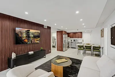a living room with a couch and a table at Stylish 3BR Retreat Steps from the Beach with Resort Amenities 1508 in Miami Beach
