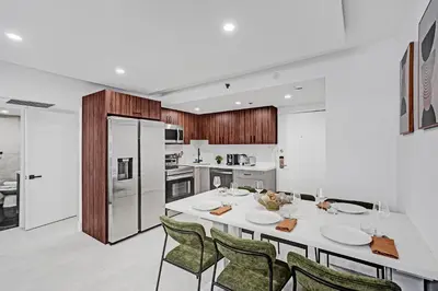 a kitchen with a large white table and chairs at Stylish 3BR Retreat Steps from the Beach with Resort Amenities 1508 in Miami Beach