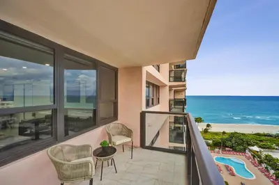 a balcony with a view of the ocean at Modern 3BR Ocean view Condo with Pools, Gym and Sauna 1407 in Miami Beach