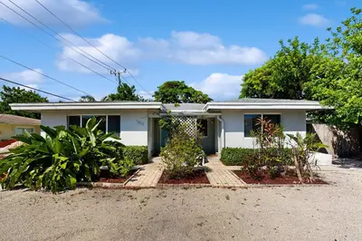 a white house with plants in front of it at Casa Sol in Fort Lauderdale