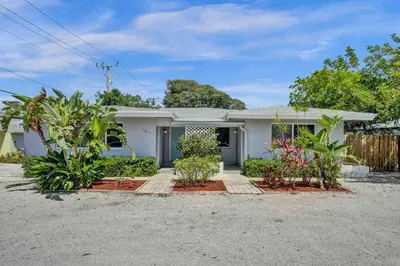a white house with plants in front of it at Casa Sol in Fort Lauderdale
