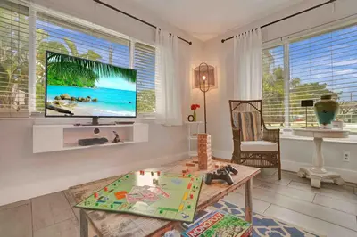 a living room with a flat screen tv on the wall at Casa Sol A in Fort Lauderdale