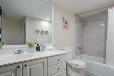 a bathroom with a sink and a toilet and a tub at 1-Bedroom Apartment with Ocean View and Balcony near Sunny Isles Beach in Sunny Isles Beach