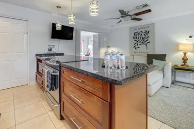 a kitchen with a counter with water bottles on it at Walkable Island City Oasis with Private Heated Pool! in Fort Lauderdale