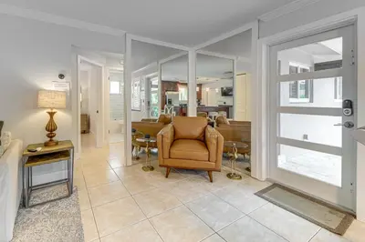 a living room with a chair and a table at Walkable Island City Oasis with Private Heated Pool! in Fort Lauderdale