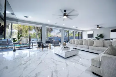 a living room with a couch and a table at Riverbend Yacht Retreat Waterfront Villa with Pool in Fort Lauderdale