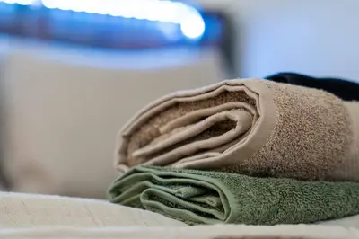 a pile of towels sitting on top of a bed at Miami Modern Studio minutes to Wynwood & Downtown in Miami