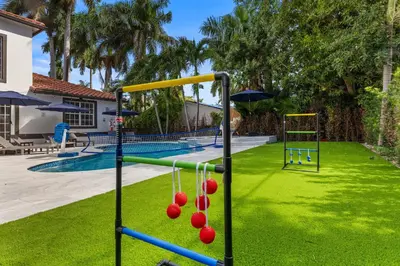 a playground with red balls in a yard at Renovated house w private heated pool grill in Hollywood