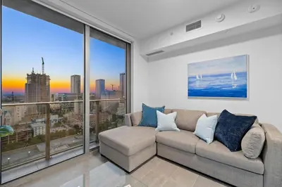 a living room with a couch and large windows at CAL KING BED Downtown Miami Free Parking Pool Gym in Miami