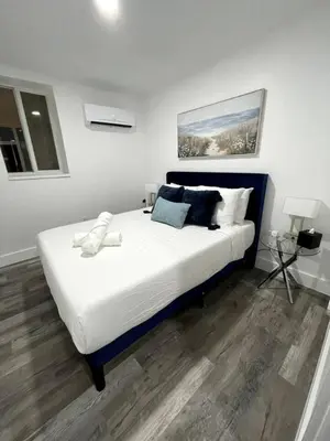 a bedroom with a large bed with white sheets and pillows at KING OF MIAMI - 2bd Retreat 1 mile from Brickell in Miami
