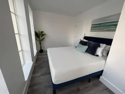 a bedroom with a white bed with pillows on it at KING OF MIAMI - 2bd Retreat 1 mile from Brickell in Miami