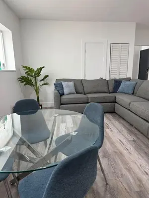 a living room with a glass table and blue chairs at KING OF MIAMI - 2bd Retreat 1 mile from Brickell in Miami