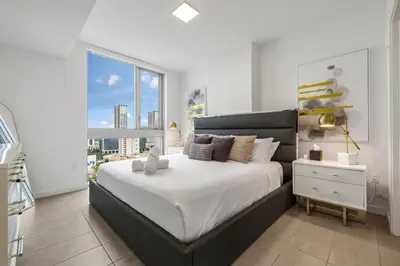 a bedroom with a large bed and a large window at KING OF MIAMI - Downtown Free Parking Pool Gym in Miami