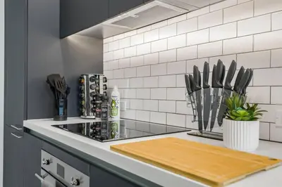 a kitchen counter with a cutting board on a stove at KING OF MIAMI - Downtown Free Parking Pool Gym in Miami