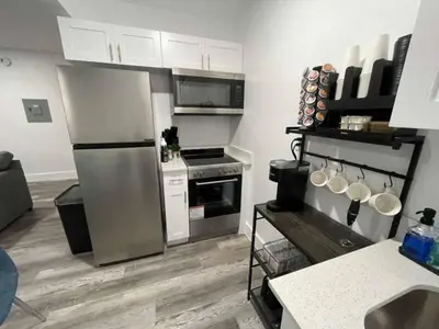 a kitchen with a stainless steel refrigerator and appliances at KING OF MIAMI - 1 mile from Brickell 2BD Apartment! in Miami