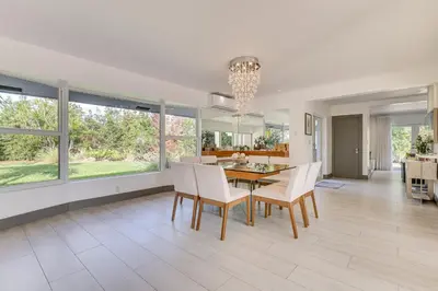 a dining room and living room with a table and chairs at Relax in the Sun! Gem 1 Mi to Las Olas Beach in Fort Lauderdale