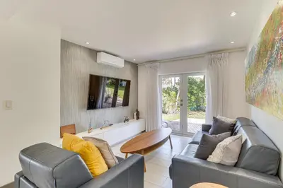 a living room with two couches and a tv at Relax in the Sun! Gem 1 Mi to Las Olas Beach in Fort Lauderdale