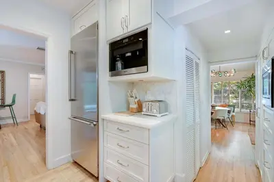 a kitchen with white cabinets and a microwave at Garden Grove- Miami Home with Private Pool in Miami