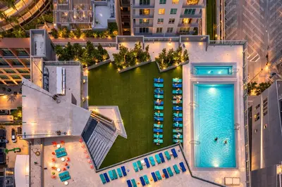 an overhead view of a pool in a city at night at Alea Miami Designer Studios Downtown in Miami