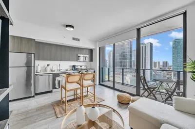 an open kitchen and living room with a view of the city at Alea Miami Designer Studios Downtown in Miami