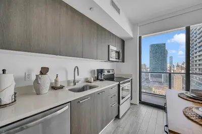 a kitchen with a view of a city skyline at Alea Miami Designer Studios Downtown in Miami