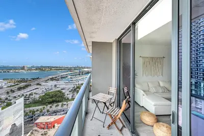 a balcony with a view of the ocean at Alea Miami Designer Studios Downtown in Miami