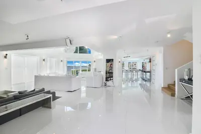 a white living room with a couch and a table at Villa Moonlight Haven in Miami Beach