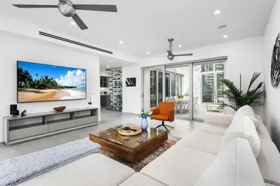 a living room with a white couch and a flat screen tv at Villa Modern Miami glamour in Miami